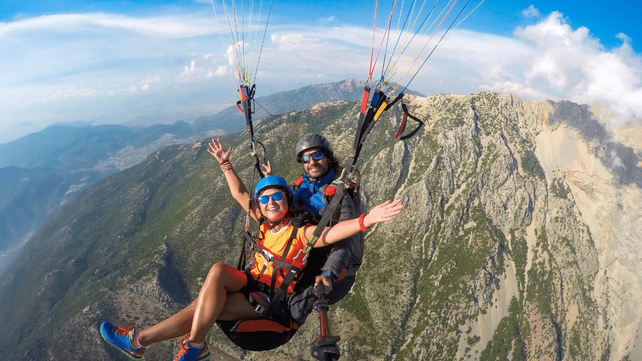 parapente en montagne : parapentiste en vol au-dessus des sommets alpins